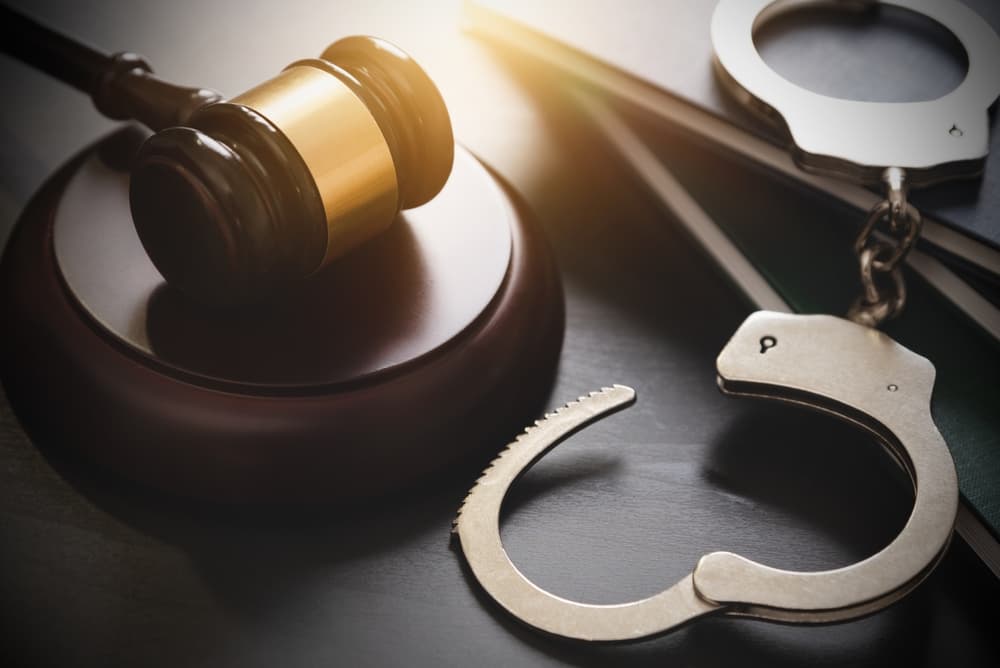Handcuffs and wooden gavel. Crime and violence
