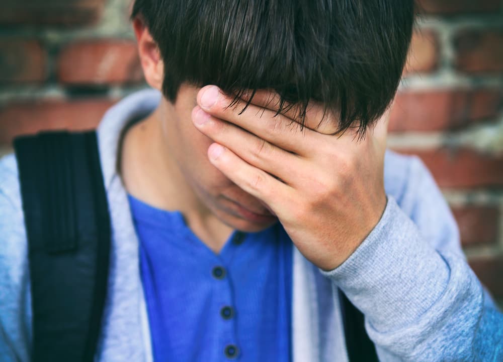 A sad teenager after facing criminal charges